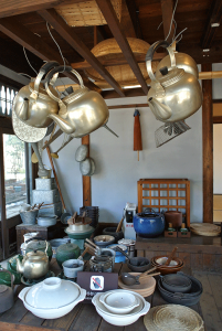 Inside Kitchenware store. You can see many utensils in those days.